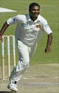 Sri Lankan off-spinner Muttiah Muralitharan celebrates after dismissing Zimbabwe's Mpulelo Nkala to break Courtney Walsh's record of 519 Test wickets 