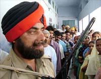 A policeman keeps a vigil at a polling booth during the final phase of the Lok Sabha elections in Amritsar