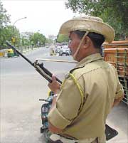 STANDING GUARD: A security person keeps vigil outside the Mandir Marg counting centre in New Delhi
