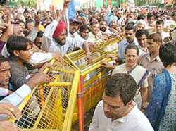 Congress President Sonia Gandhi, her son Rahul Gandhi and daughter Priyanka Vadra meet party workers outside her residence in New Delhi on Friday. 