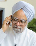 Senior Congress party leader Manmohan Singh talks on a mobile phone while conducting an interview in New Delhi
