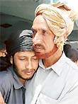 Liaquat Ali, a militant of the Hizbul Mujahideen group, embraces his father after surrendering to security forces in Reasi in Jammu and Kashmir on Monday. 