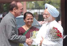 Prime Minister Manmohan Singh is greeted by Parliamentary Affairs Minister Ghulam Nabi Azad on his arrival at Parliament House to attend the first session of the 14th Lok Sabha in New Delhi on Wednesday. 