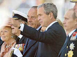 US President George W. Bush chats with French President Jacques Chirac next to Russian President Vladimir Putin on Sunday in Arromanches before the ceremony marking the 60th anniversary of the D-Day landings in Normandy.