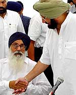 Capt Amarinder Singh and Mr Parkash Singh Badal shake hands at the all-party meeting in Chandigarh on Saturday. 