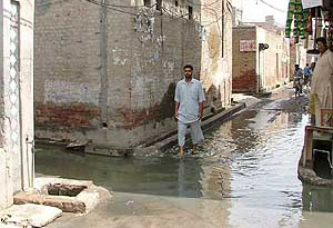 A resident crosses a lane of Gandhi Nagar in Muktsar on which sewerage water has accumulated.