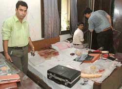 Crime branch sleuths in the bedroom of a Vasant Vihar Enclave house where Lieut-Gen H.S. Sethi (retd) was found murdered 