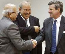 US administrator in Iraq Paul Bremer, Iraqi Prime Minister Iyad Allawi and the countrys most senior judge Midhat Mahmoud smile during the handover of sovereignty ceremony in Baghdad on Monday.