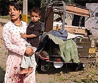 A Kashmiri woman wails near a damaged vehicle after an explosion in Srinagar on Saturday. 