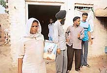 Members of a suicide victims family in Sangrurs Bhutal Khurd await help