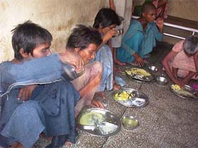 Inmates of the All-India Pingla Ashram having food on the ashram premises