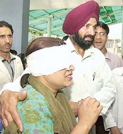 A woman is taken for treatment after she was wounded in a grenade explosion on Saturday in Anantnag