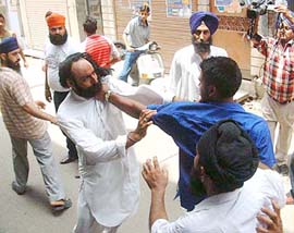 Two groups of Akali workers come to blows during the SGPC election at Chowk Parag Das in Amritsar on Sunday.