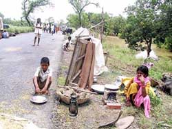 Villagers take shelter on National Highway-57 after their houses were flooded by the Bagmati river in Darbhanga district of north Bihar on Tuesday