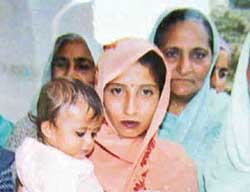 Kusum Lata, wife of kidnapped driver Ataryami, with her daughter.
