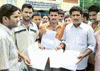 Truck drivers show fake international driving licences and documents provided to them by travel agents in Nangal. 