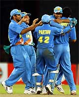 Indian players celebrate after winning the match against Sri Lanka at the Asia Cup in Colombo on Tuesday. India won by four runs to qualify for the final. 
