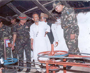 Dr Anil Prakash Joshi explains the functioning of a water mill to Army officers