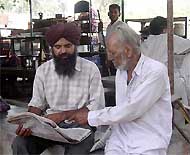 Gulzar Singh (right) of Jandiali Khurd, Ludhiana, scans a list of youths killed in fake encounters by the Punjab police. The list was released by the NHRC recently. 