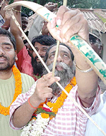 Shibu Soren, JMM President and former Union Coal Minister, holds his party's symbol as he resurfaced on Friday in Ranchi