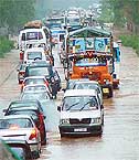 Hundreds of vehicles drive through the flooded Chandigarh-Patiala highway on Tuesday.