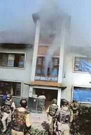 Smoke billows from a building housing a CRPF battalion during a gunbattle between suspected militants and security forces in the Rajbagh area of Srinagar