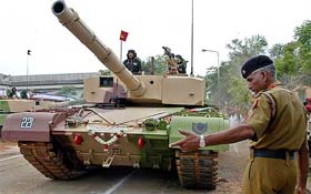 A soldier guides Indias indigenously developed main battle tank, the Arjun, as its rolled out during an induction ceremony in Chennai