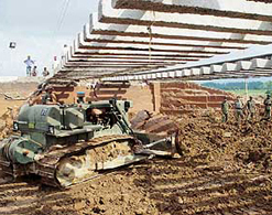 Army bulldozers fill up the breach on the Ambala-Amritsar rail line near Shambhu on Monday.