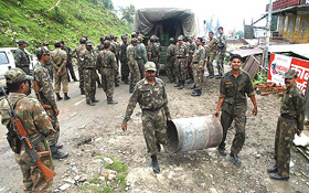 Army personnel take position near Narkanda on the Rampur road in Himachal Pradesh on Thursday in view of the red alert following the bursting of the Parchu lake in Tibet.