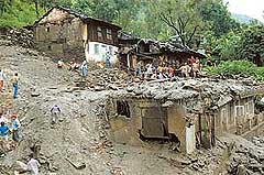 Rescue teams search for bodies buried under the debris of four houses damaged by cloud burst at Jagat-Khana in Kulu district of Himachal Pradesh