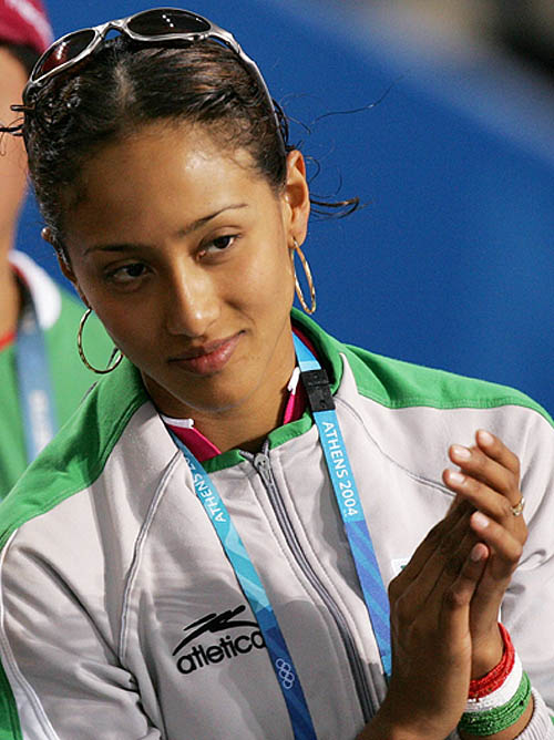 Mexican silver medalist Iridia Salazar cheers on team mate Victor Manuel Estrada in the men's under 80kg first round taekwondo