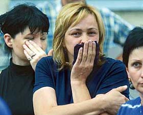 Women cry as they stand near the school seized by attackers in Beslan, North Ossetia, Russia