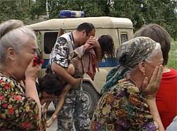 An Interior Ministry officer carries an injured child after special forces stormed a school seized by armed militants in the town of Beslan, North Ossetia, near Chechnya, on Friday.