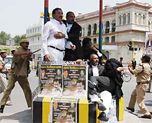 Policemen chase lawyers during a clash at Hazratganj in Lucknow on Friday. 