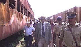 Justice U.C. Bannerji inspects a burnt coach of the Sabarmati Express of Godhra carnage for preliminary observation along with three other experts at Godhra on Wednesday. 