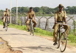 BSF personnel patrol the fenced border with Bangladesh at Lankamura village near Agartala. Security has been beefed-up in the state following increased insurgent attacks in the North-East.