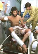 Medics tend to a wounded person after a car bomb explosion in Multan on Thursday.