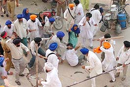 A Shiromani Akali Dal (Amritsar) activist being beaten up by SAD supporters in the court complex in Patiala on Tuesday.