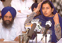 An SGPC member, Bibi Kiranjot Kaur, addresses a press conference in Amritsar on Wednesday. The SGPC secretary, Mr Dilmegh Singh, is also seen in the picture. 