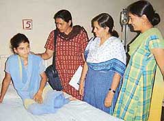 Activists of womens organisations break the news of validation of her marriage by Asanda villagers to Sonia at the PGIMS, Rohtak, on Thursday.