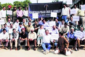 Newspaper and news agency employees hold a demonstration in support of their demand for a new wage board in the Sector 17 Plaza