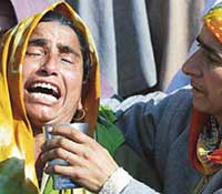 A Kashmiri woman wails as she watches the funeral of Bashir Ahmed, shot dead by militants in Cheke-Kawoosa village, 25 km north of Srinagar, on Tuesday. 