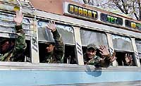 Army soldiers wave as they leave Anantnag, 55 km south of Srinagar, on Wednesday as part of a partial troop withdrawal from Jammu and Kashmir.
