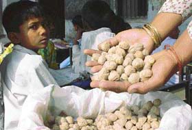 A staff member of Government Primary School in Keorak in Kaithal district shows the fungus-infested soyabean nuggets being supplied for mid-day meals