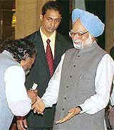 Jharkhand Mukti Morcha leader Shibu Soren bows before Prime Minister Manmohan Singh before being sworn in as a Cabinet Minister at Rashtrapati Bhavan on Saturday. 