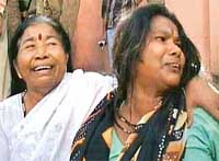 Grieving relatives of people killed in a train accident in Bhopal on Sunday. At least 12 persons were killed when they were run over by a speeding train after getting off another train on a parallel line. 