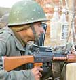 A jawan takes position during an encounter at Sopore on Friday.