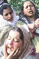 Relatives of Mehraj-ud-Din, a driver who was killed in a landmine explosion at Wachi village some 65 km south of Srinagar, wail at his residence in Srinagar on Sunday.