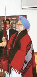 Prime Minister Manmohan Singh with a shawl and traditional Naga spear presented by Naga leaders 