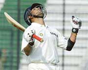 Sachin Tendulkar celebrates after making his 34th century against Bangladesh on the second day of the first Test in Dhaka on Saturday. He thus equalled Sunil Gavaskar's world record of the highest number of centuries in Test cricket.